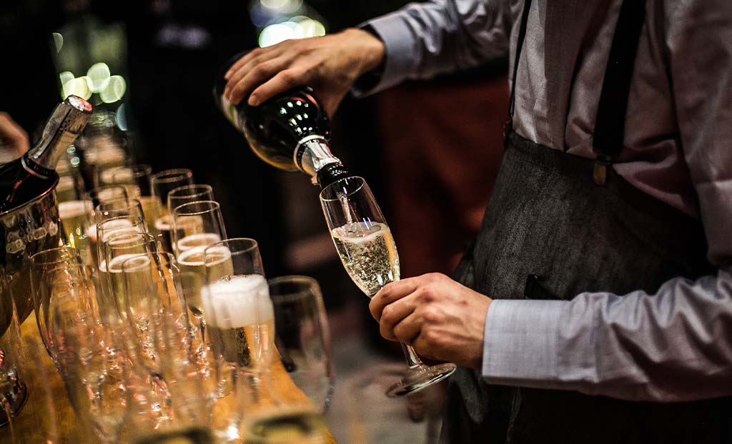 Pouring champagne at a wedding event