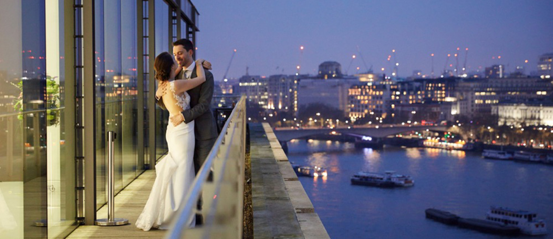Newlyweds on the Sea Containers balcony at night